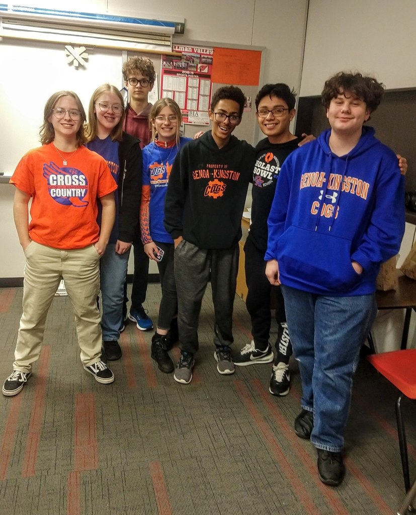 cross country students smile in classroom