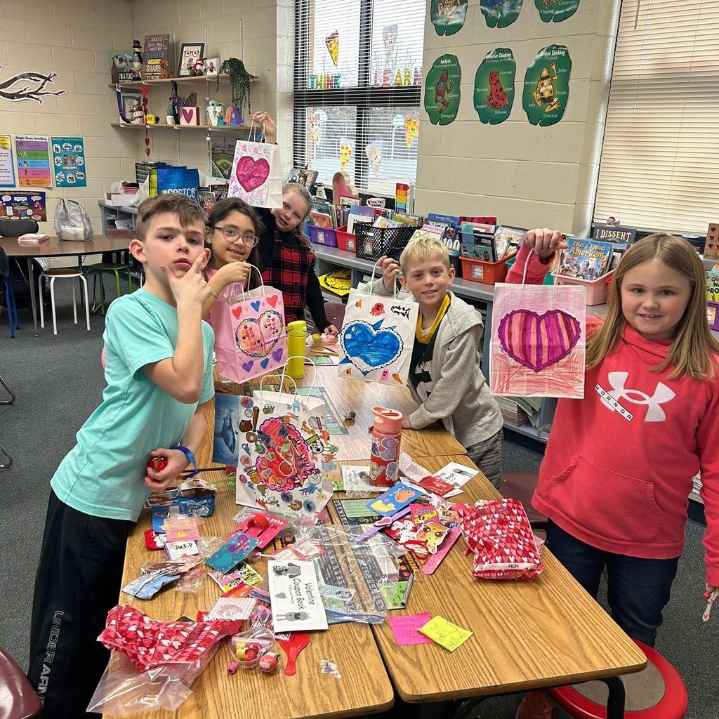students eating candy and showing valentine's bags